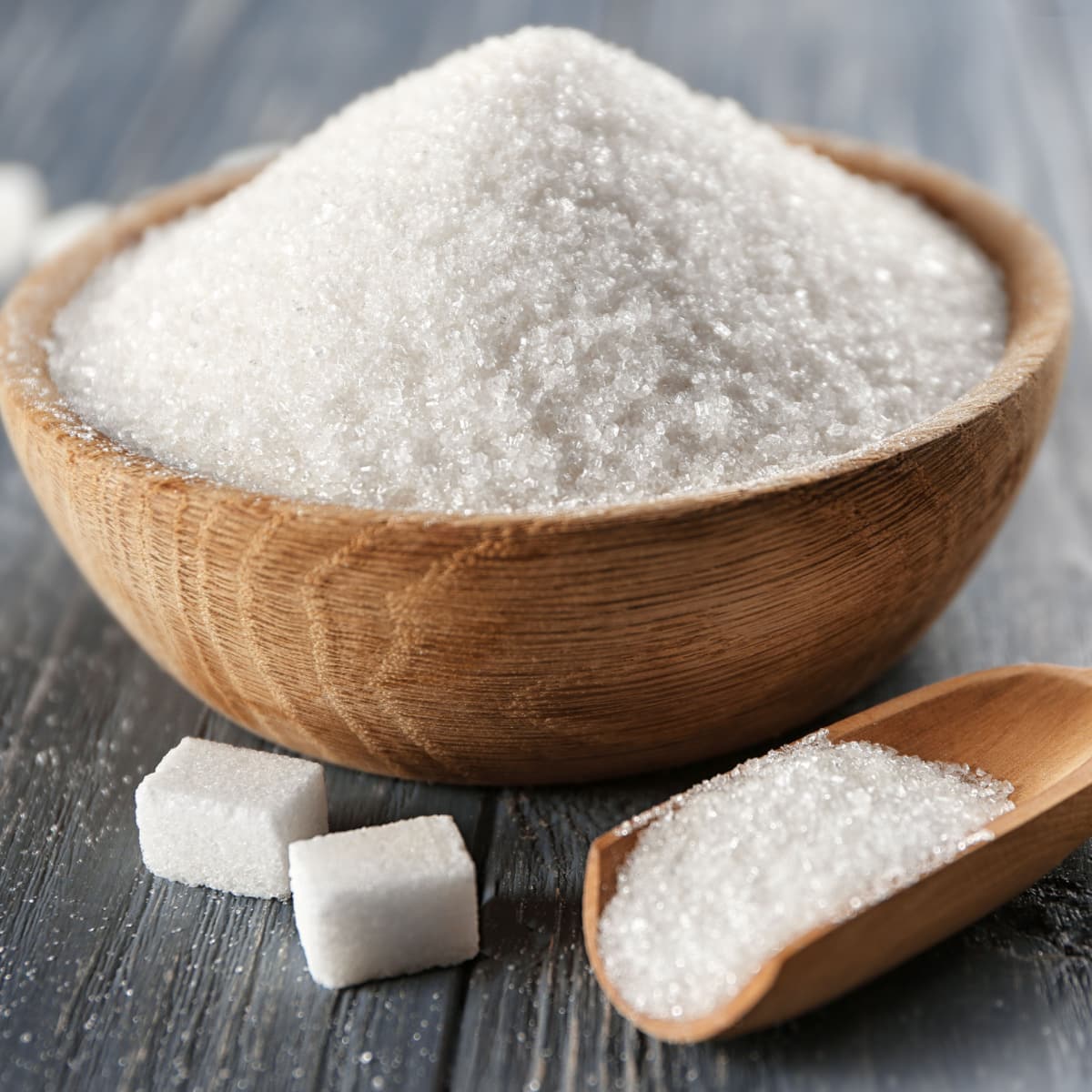 White Table Sugar on a Wooden Bowl and Scooper
