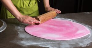 Woman Preparing Pink Fondant for Cake Decorating