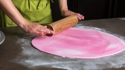 Woman Preparing Pink Fondant for Cake Decorating