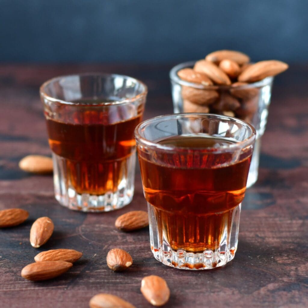 Fresh Almond Nuts and Almond-Flavored Liqueur in Shot Glasses