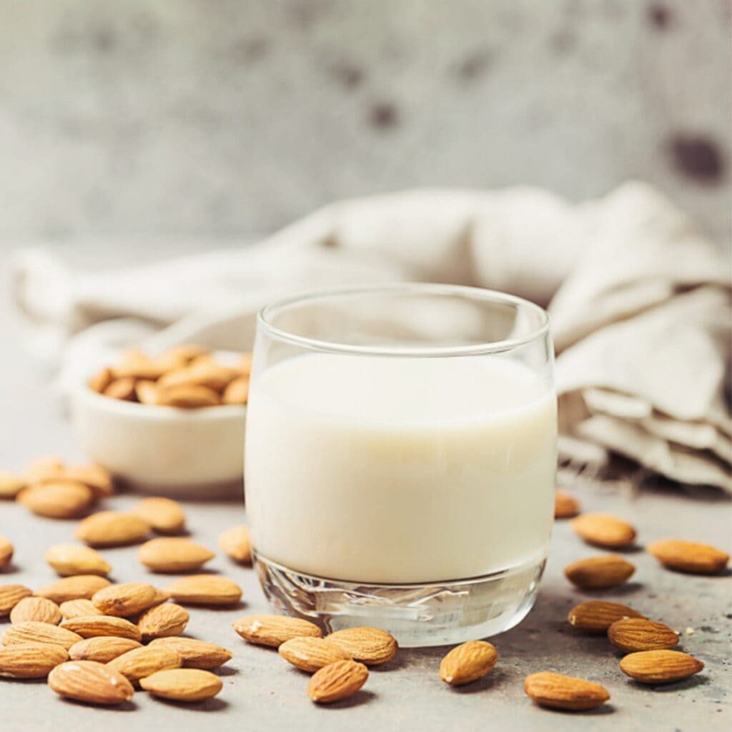 Almond Nuts and Fresh Almond Milk in a Glass