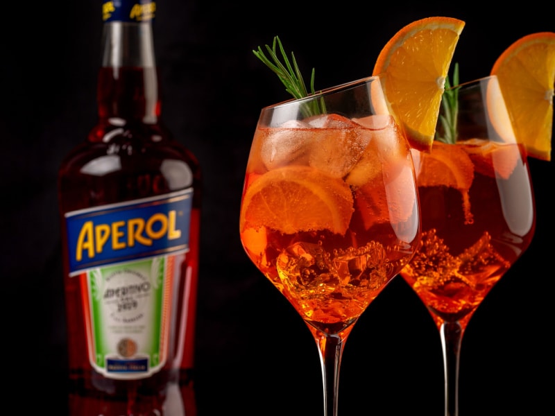 A Bottle of Aperol and Cocktails on Goblet