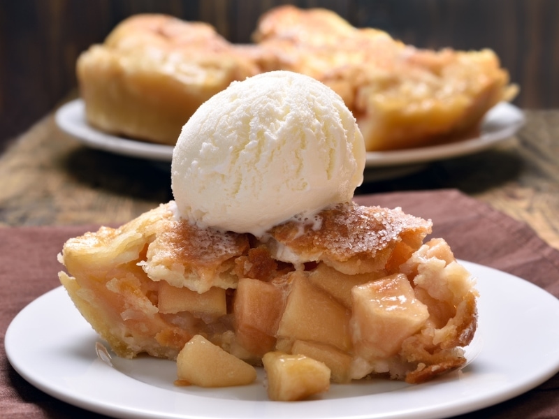 Apple Pie Slice With Scoop of Vanilla Ice Cream on Top