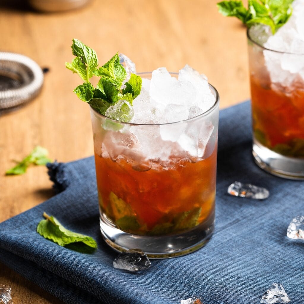 Rye Whiskey vs. Bourbon (What's the Difference?) featuring Boozy Bourbon Whiskey with Mint Leaves Over Ice
