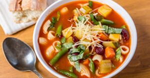 Bowl of Homemade Minestrone Soup with Beans, Potatoes, Carrots and Pasta