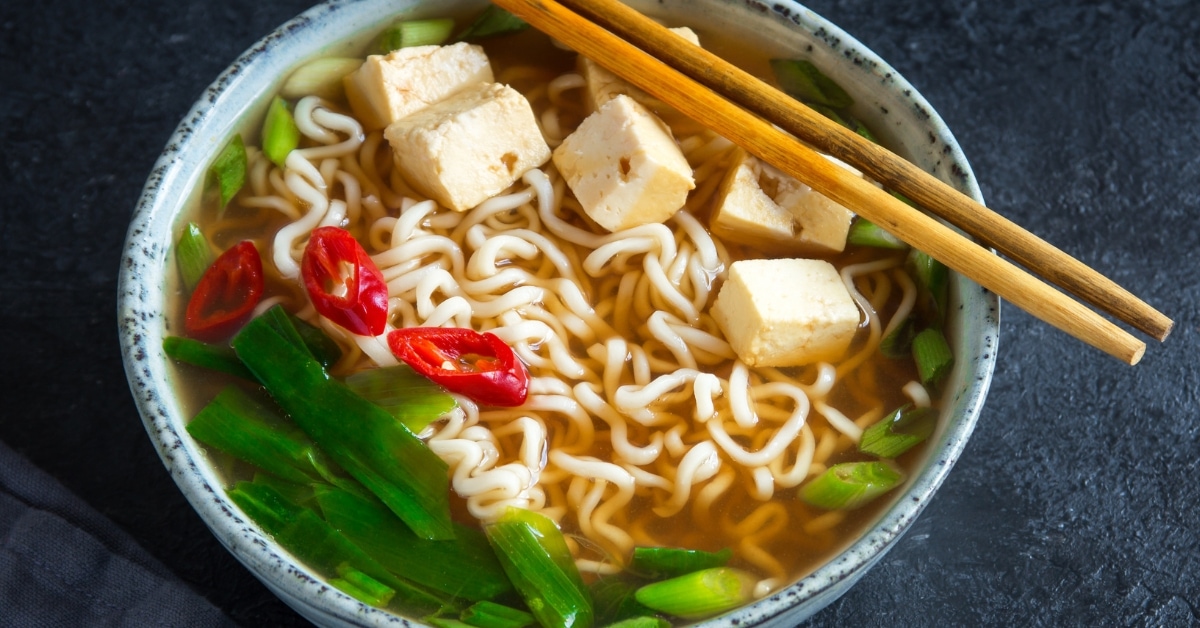 Bowl of Warm Ramen Noodle Soup with Tofu and Spices