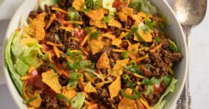 Bowl of Homemade Ground Beef Taco Salad with Cheese and Lettuce