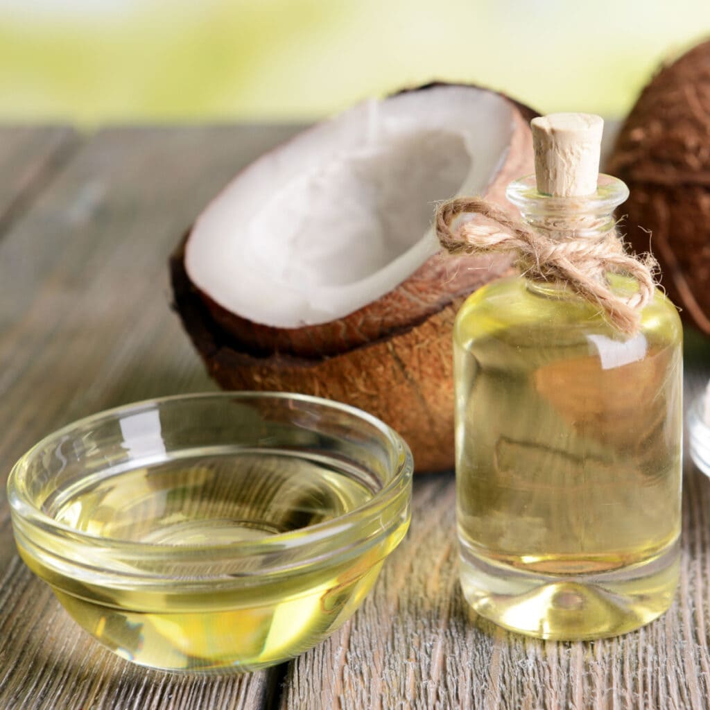 Coconut Oil and Coconuts on a Wooden Table