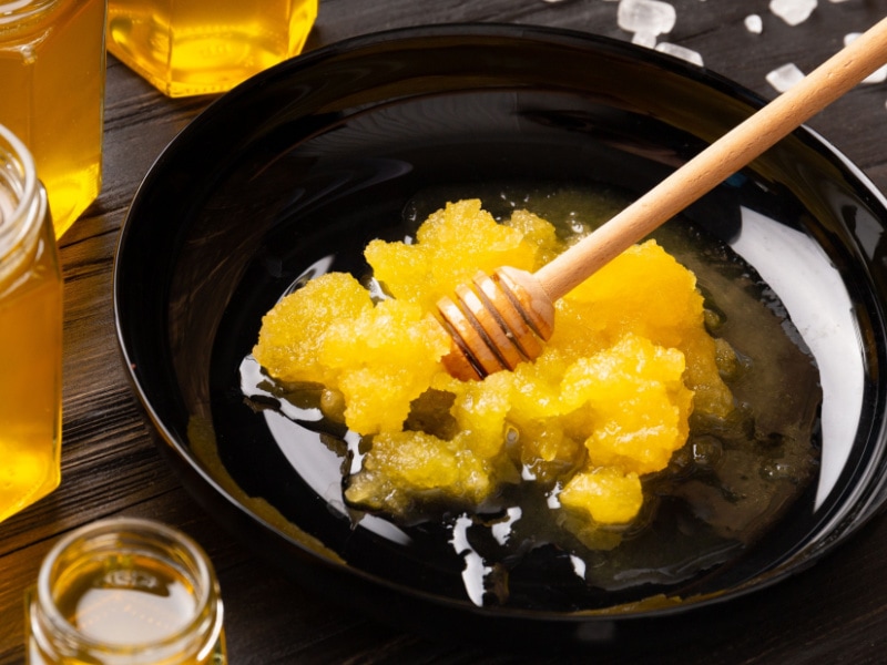 Crystallized Honey Melting in a Skillet, Stirred with a Honey Dipper