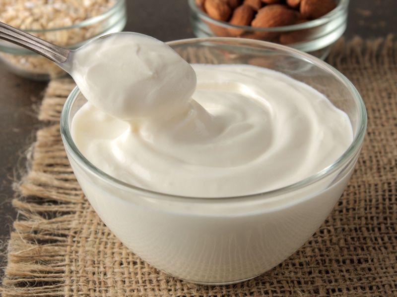 Greek Yogurt in a Clear Bowl with a Spoon