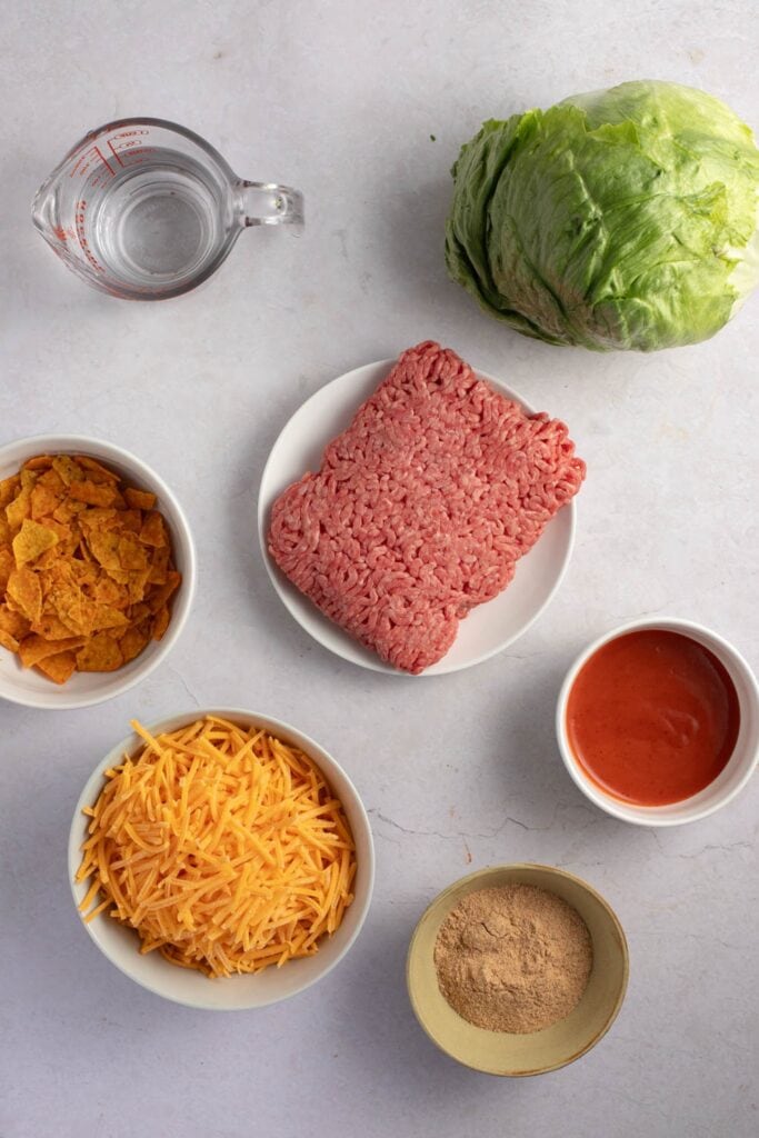 Ground Beef Taco Salad Ingredients - Ground Beef, Taco Seasoning, Iceberg Lettuce, Cheddar Cheese, Tortilla Chips and Catalina Salad Dressing