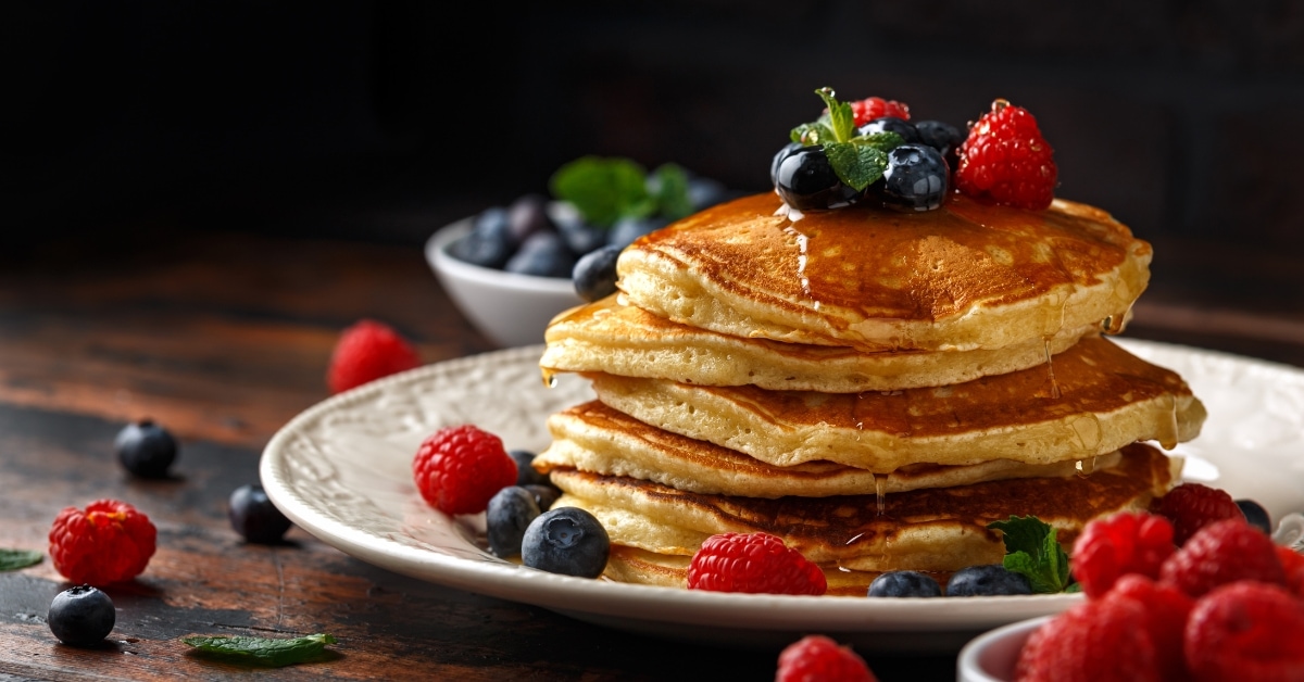Homemade Fluffy Pancakes with Syrup and Berries