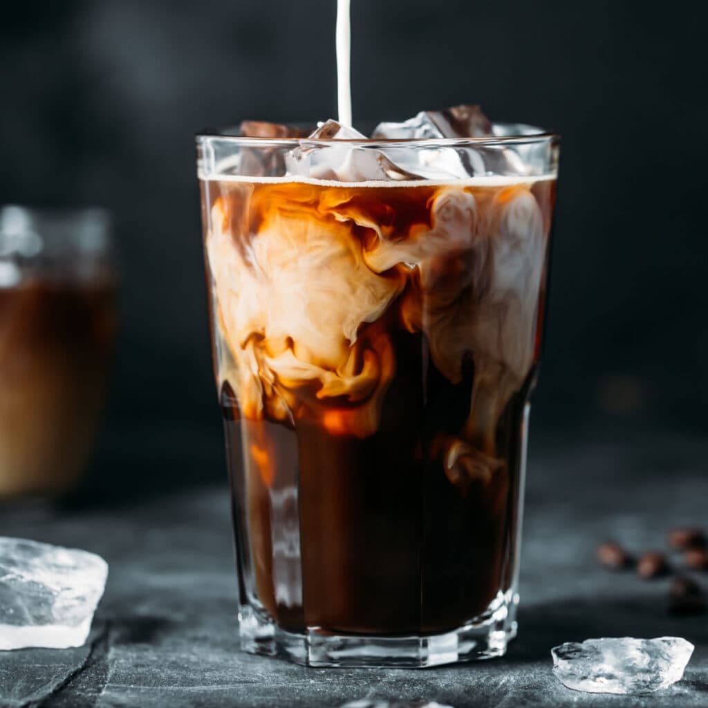 Cold Brew vs. Iced Coffee featuring Ice Coffee with Milk Swirling