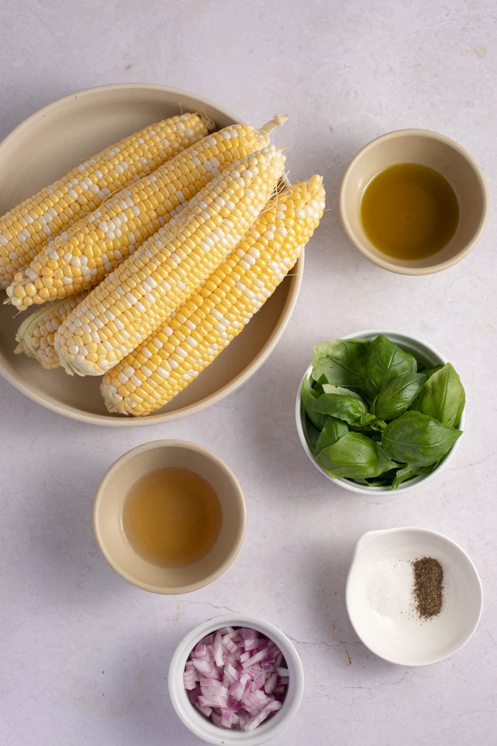 Ina Garten Corn Salad Ingredients - Corn, Red Onion, Cider Vinegar, Olive Oil, Salt, Pepper and Basil Leaves