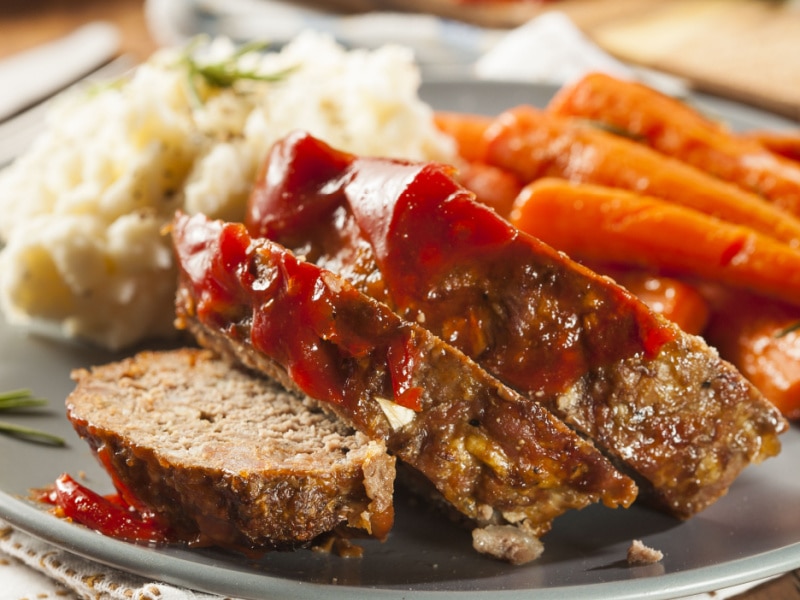 Sliced Meatloaf on a Plate with Mashed Potato and Carrots