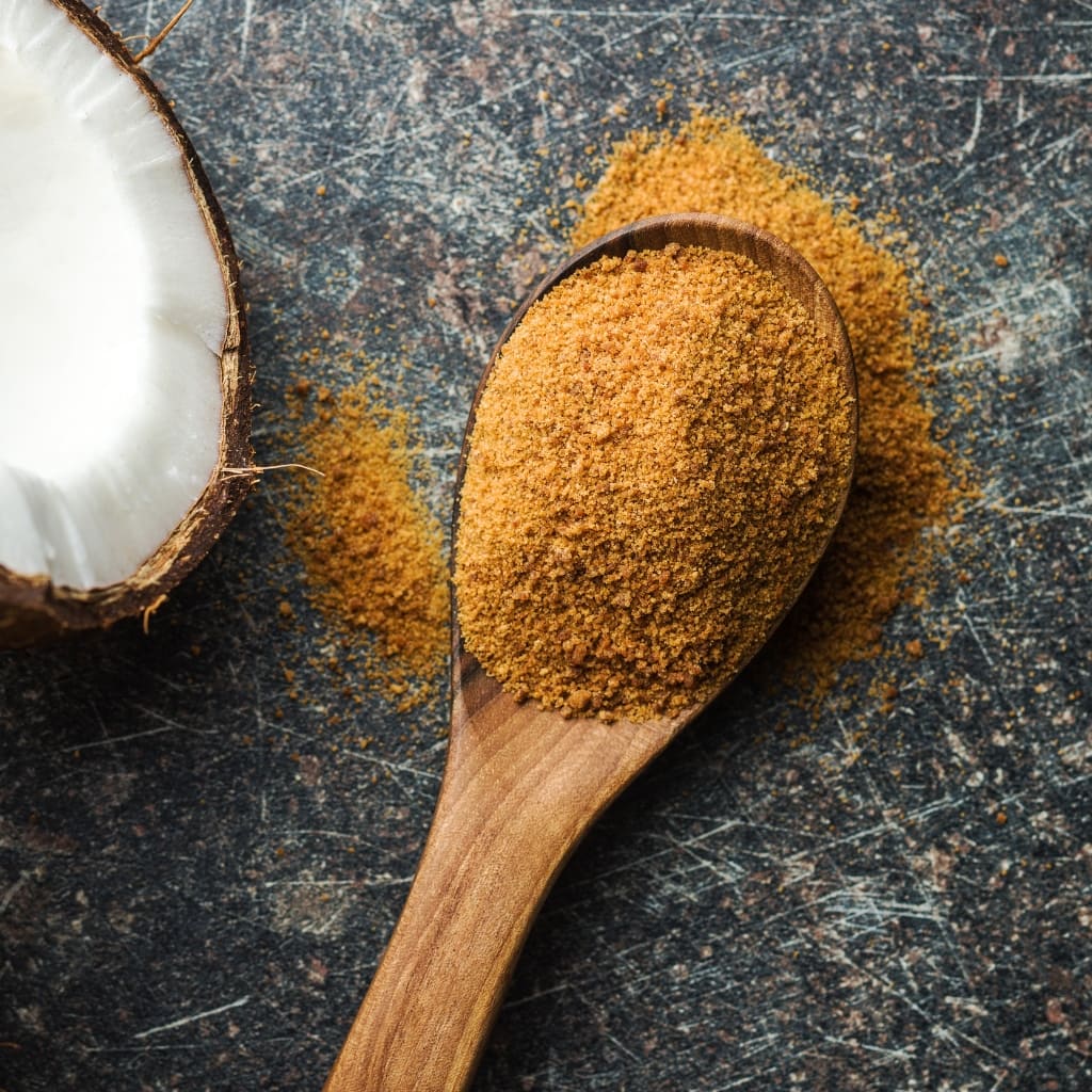 Raw Organic Coconut Sugar in a Wooden Spoon
