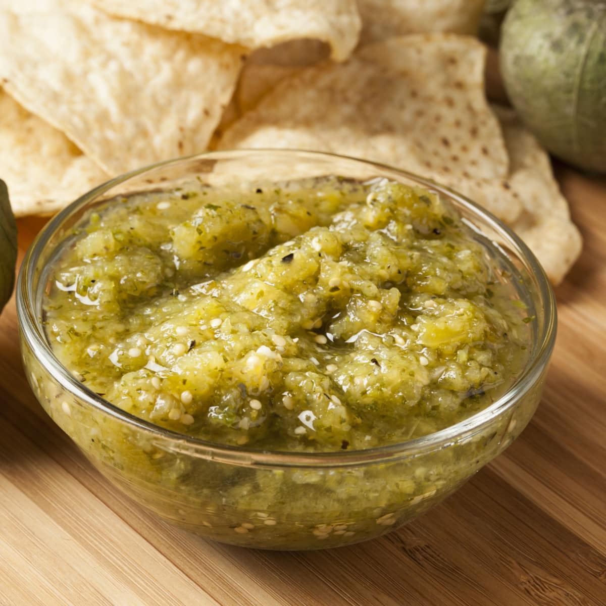 A Bowl of Homemade Salsa Verde on a Wooden Table