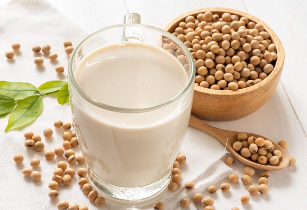 A Glass of Soya Milk in a and a Bowl of Soy Beans