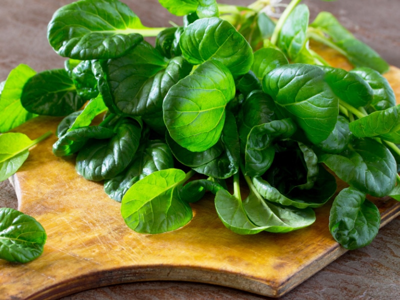 Fresh Spinach Leaves on a Wooden Cutting Board
