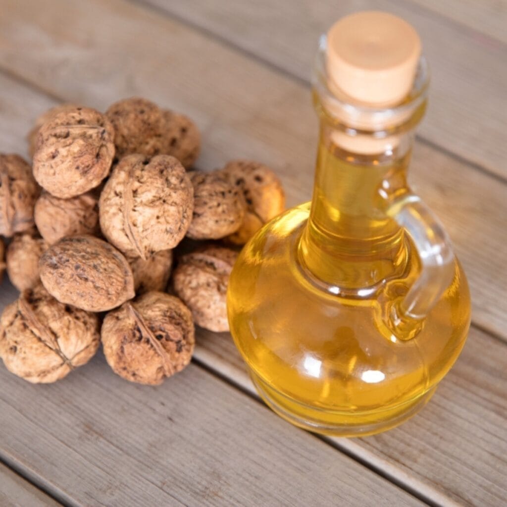 Pile of Walnuts and a Bottle of Homemade Walnut Extract