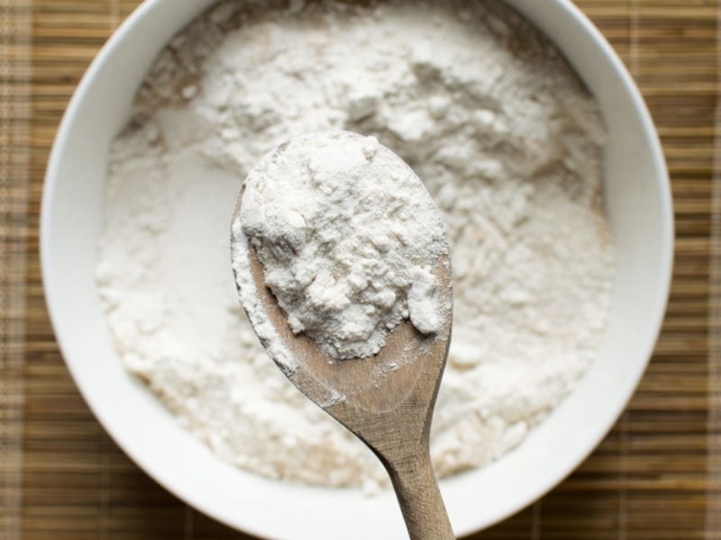 All-Purpose Flour on a Wooden Spoon over a Bowl of All-Purpose Flour