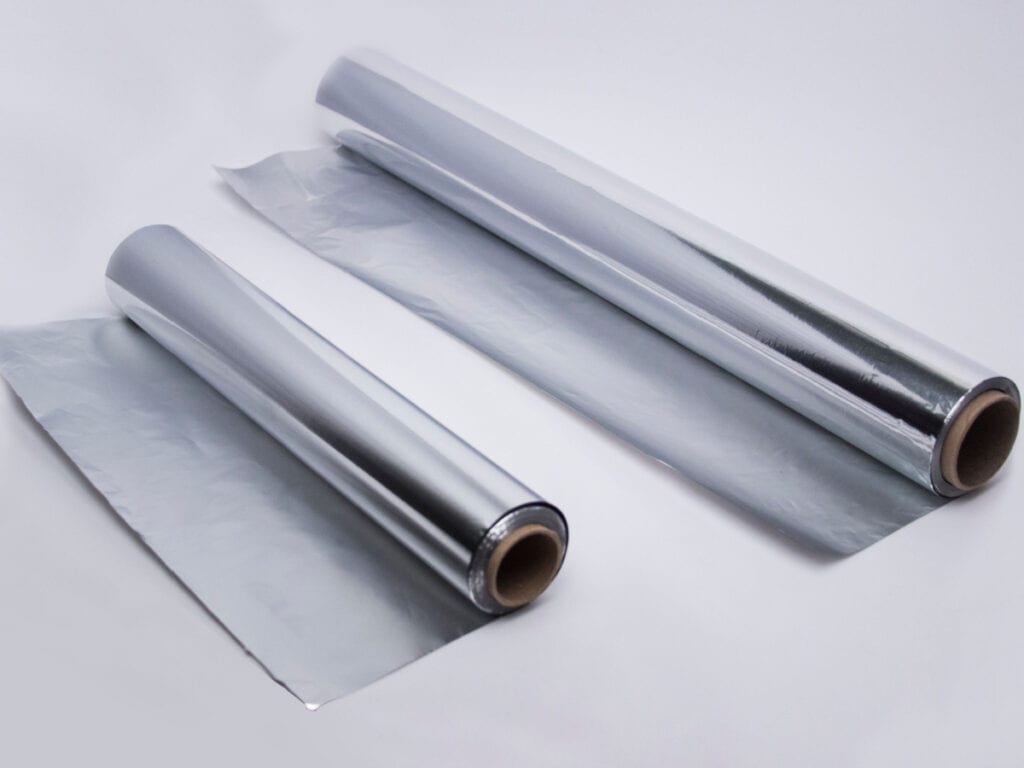 Long and Short Aluminum Rolls on White Surface