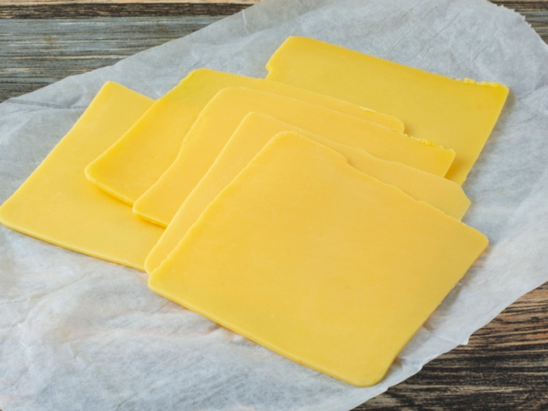 Six Slices of American Cheese on a Parchment Paper