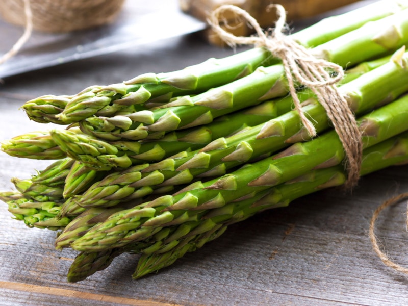 Tied Bunch of Asparagus on a Wooden Table