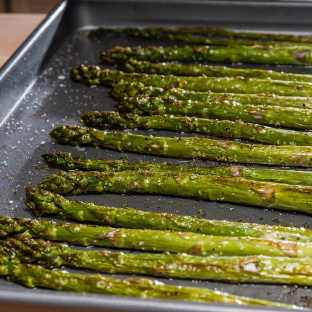 Roasted Asparagus on a Baking Pan with Oil and Seasonings