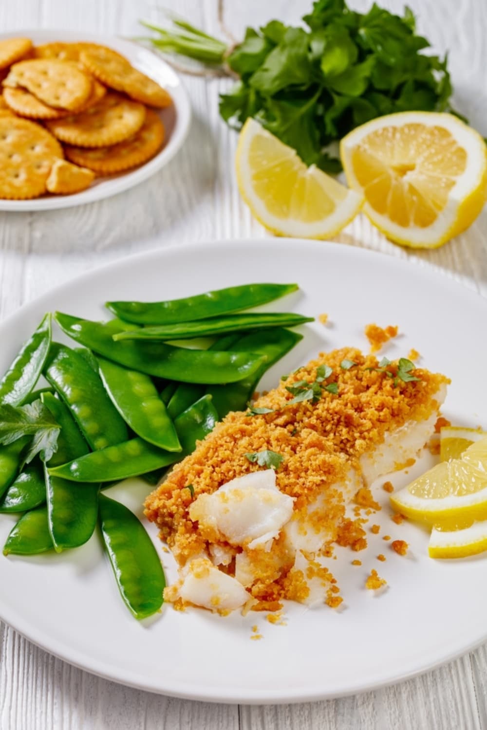 Baked Cod Served With Greens and Lemon Slices