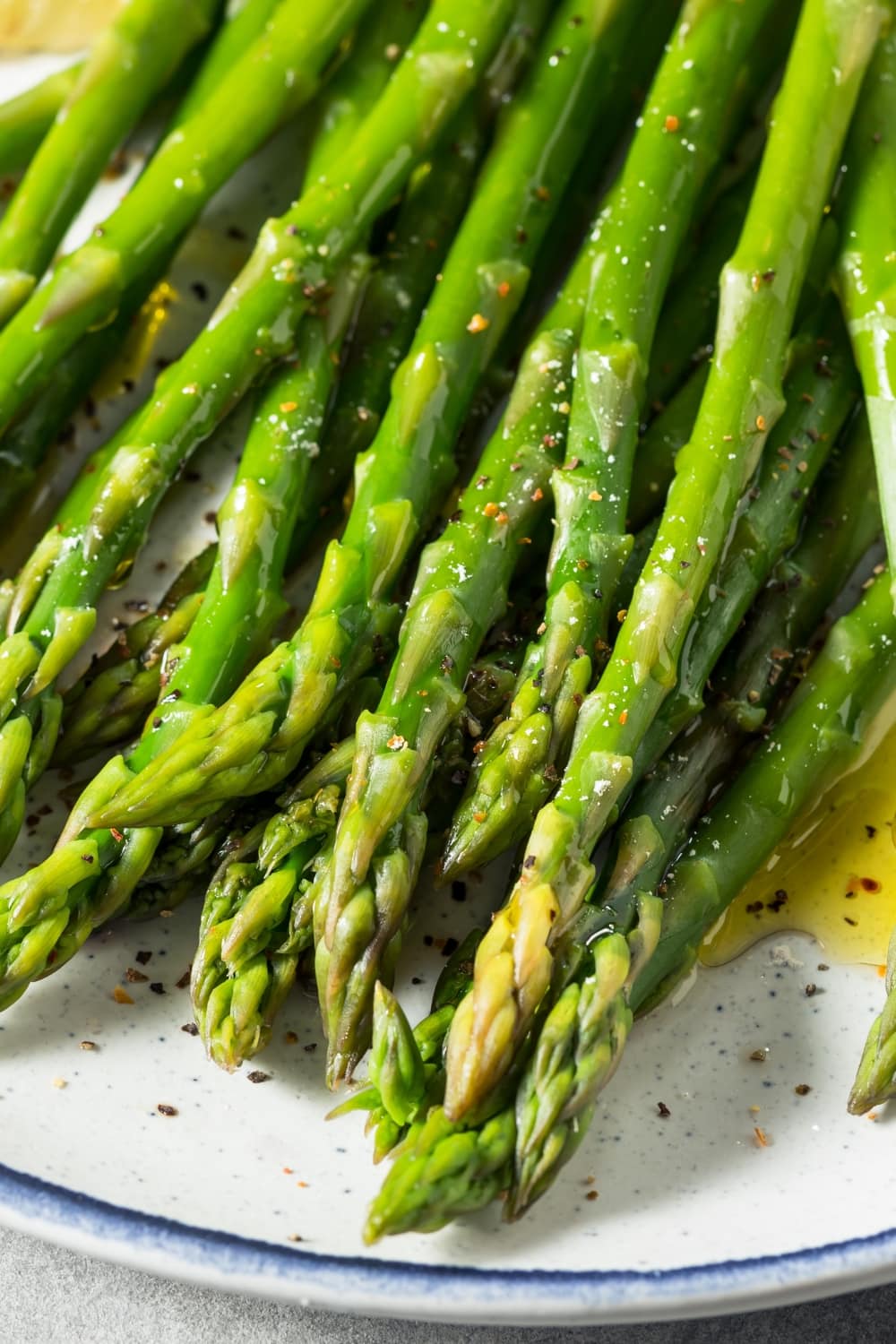 Oven-Baked Asparagus in Oil with Seasonings on a Plate
