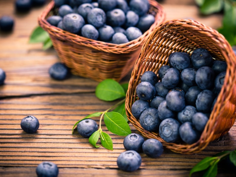 Basket Full of Blueberries on a Wooden Table