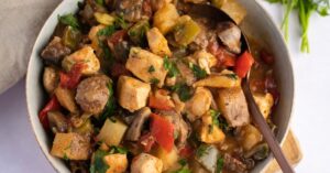 Bowl of Chicken Murphy with Italian Sausage, Parsley, Tomatoes and Mushrooms