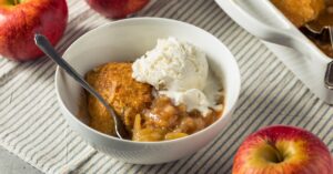 Bowl of Homemade Slow Cooker Apple Cobbler with Ice Cream