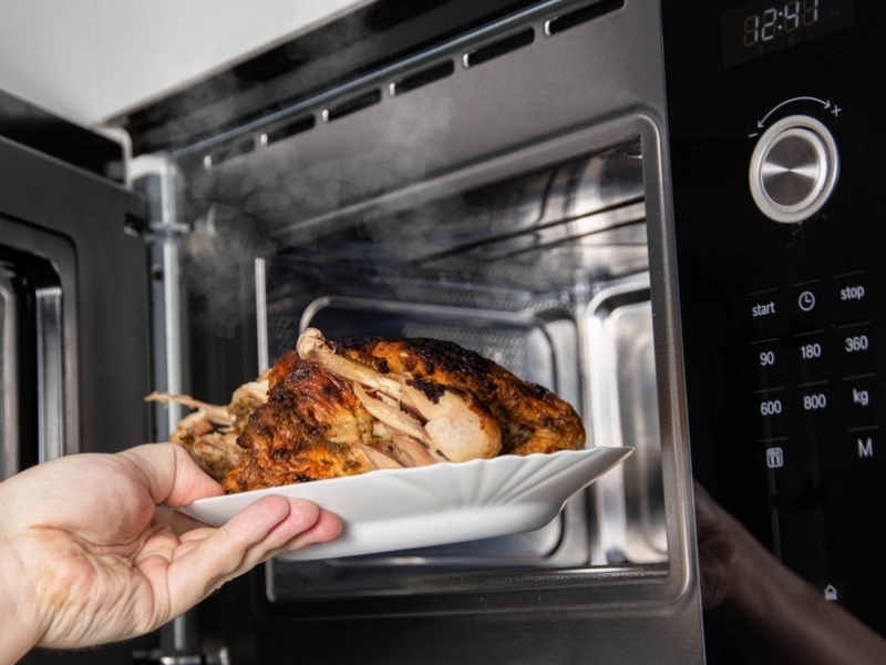 Cooked Chicken Placed Inside a Microwave Oven