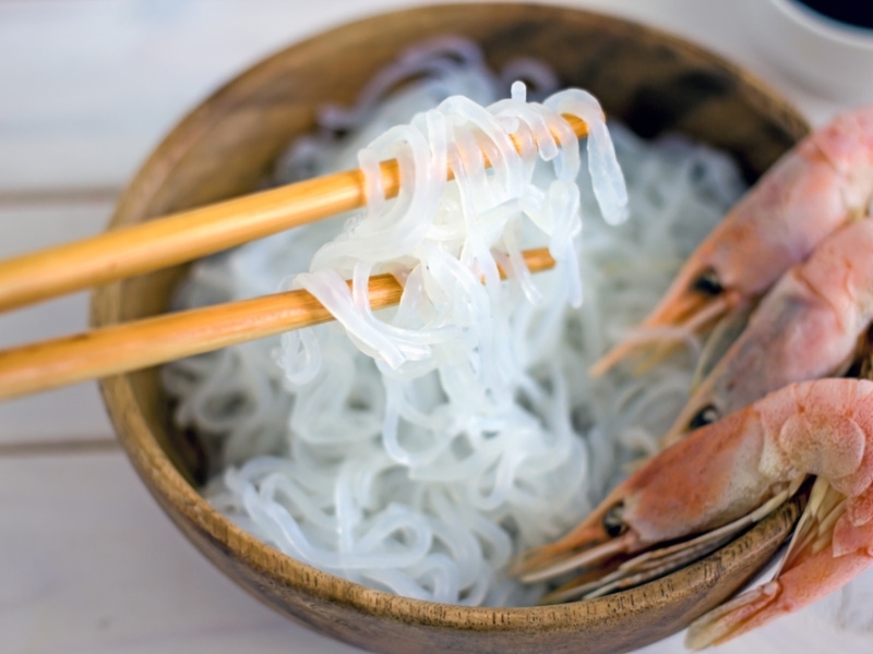 Chopsticks Picking a Cooked Konjac Noodles With Boiled Shrimp on Sides