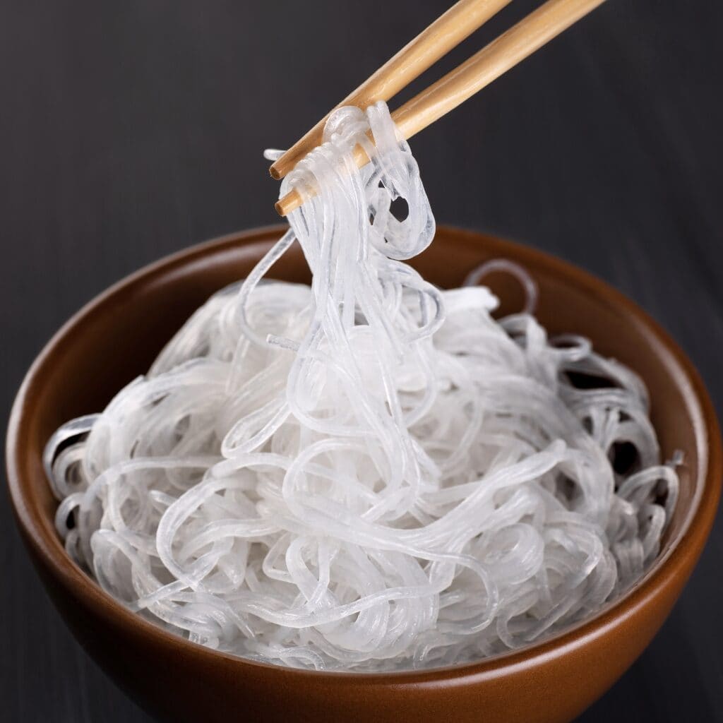What are Glass Noodles featuring Cooked Glass Noodles in a Wooden Bowl and Wooden Chopsticks