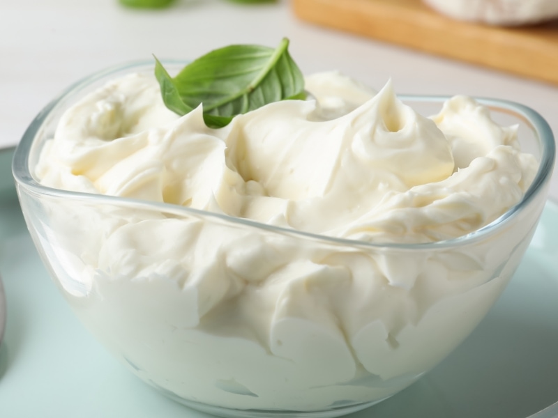 A Bowl of Cream Cheese with Fresh Basil Leaf on Top