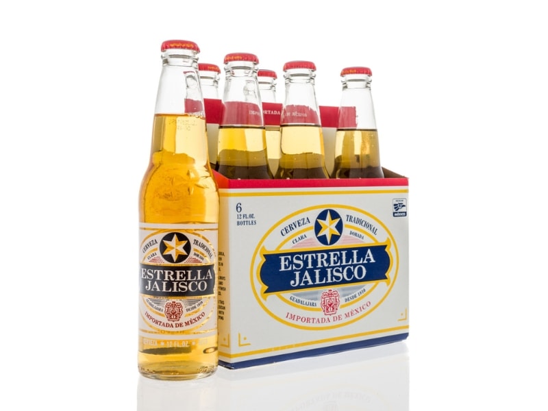 Six Pack of Estrella Jalisco Beer in Glass Bottles With One Bottle on the Side