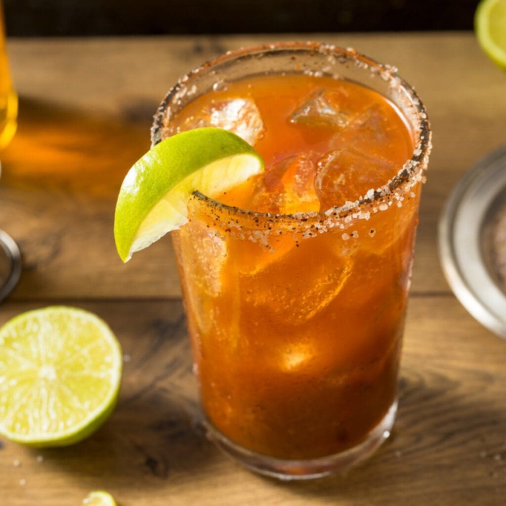 Iced Michelada, a Mexican Cocktail on a  Salted Rim Shot Glass
