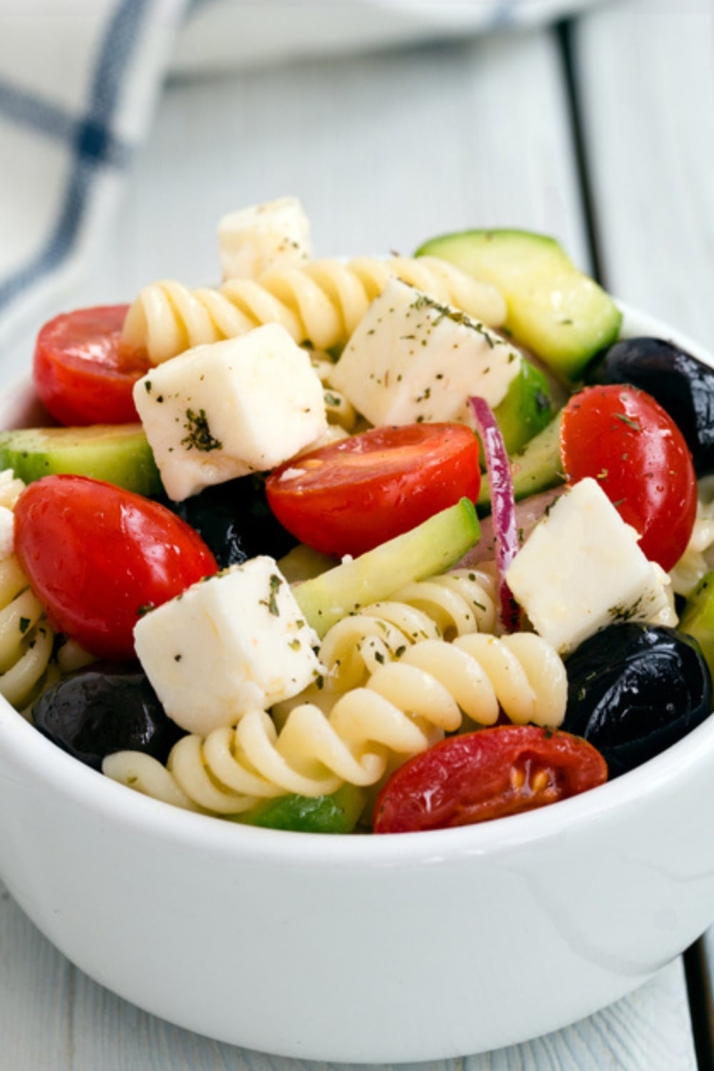 Close Up of Greek Pasta Salad in a Small Ceramic Bowl