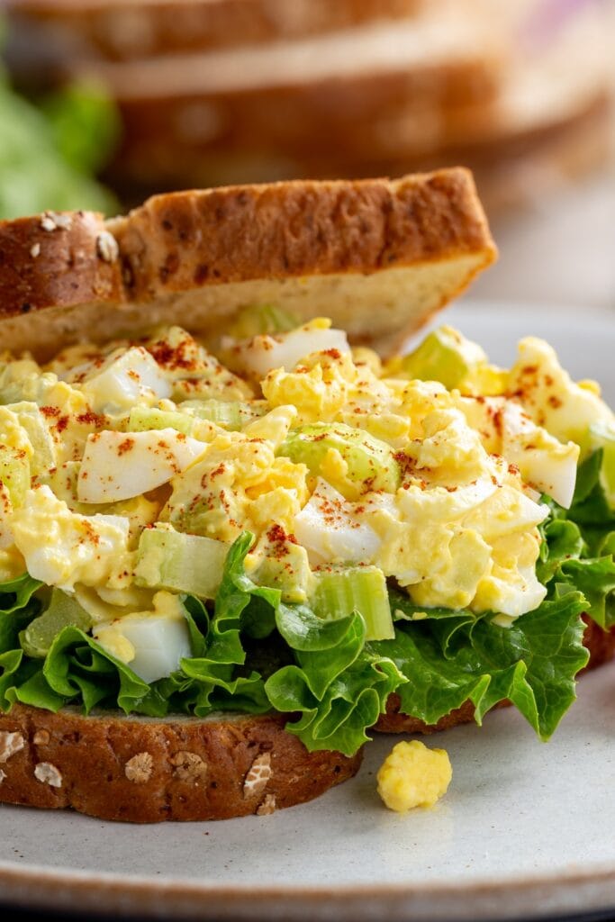 What to Serve with Egg Salad Sandwiches (23 Easy Sides): egg salad with lettuce on whole wheat bread.