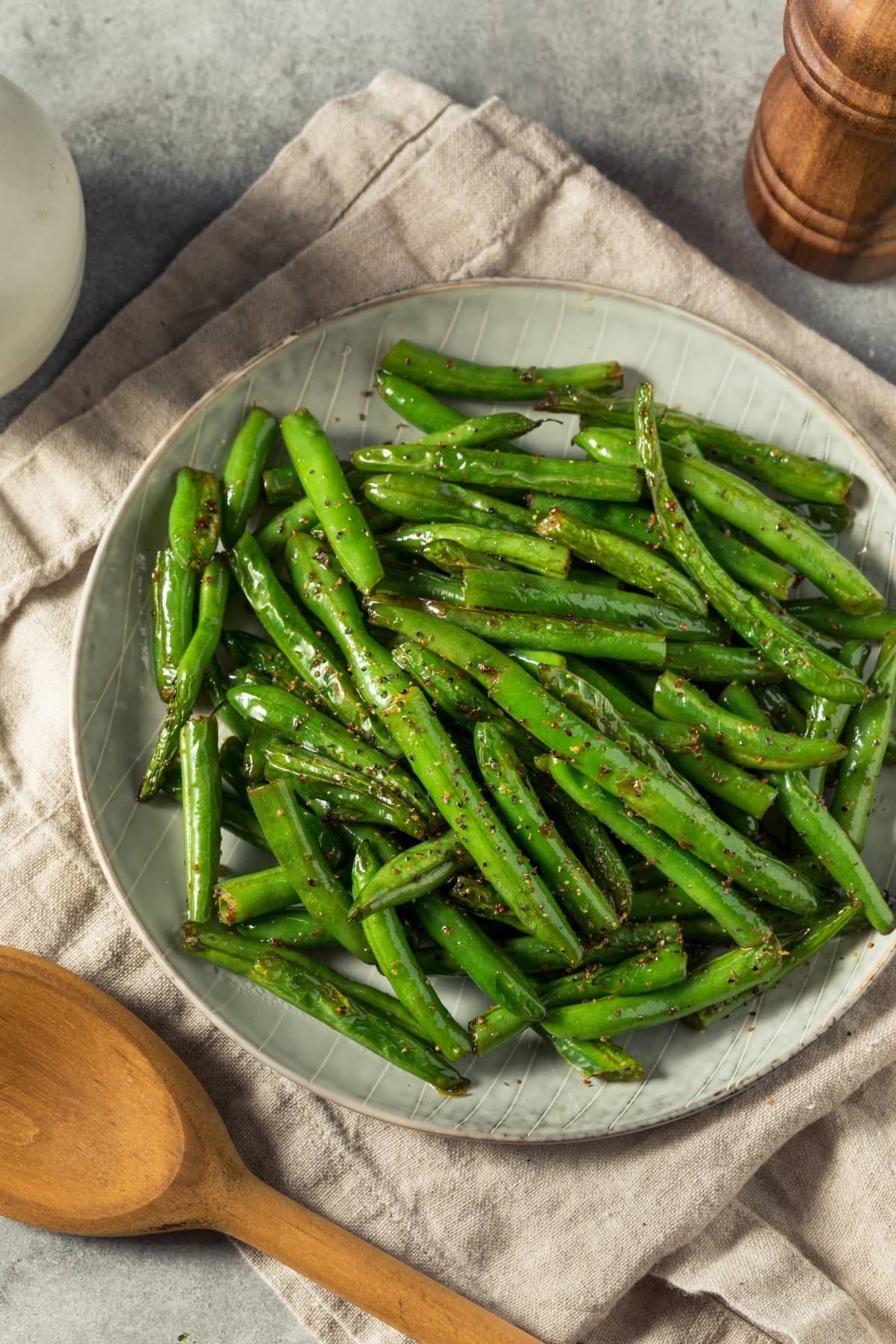 How to Steam Green Beans in the Microwave featuring a Dish of Microwave-Steamed Green Beans, Seasoned with Salt and Black Pepper