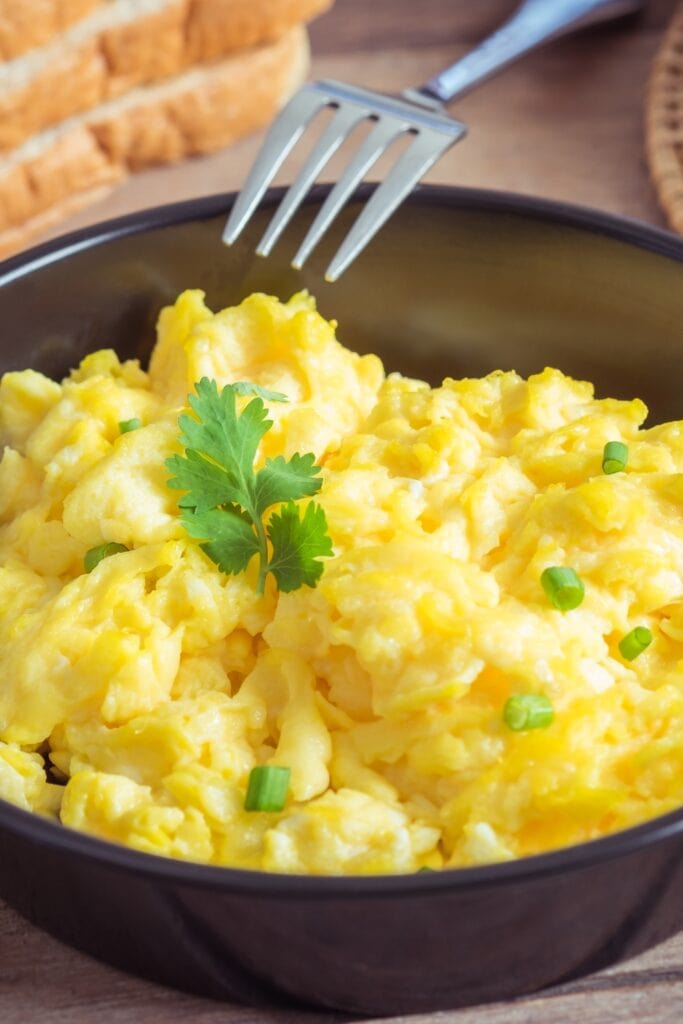 Homemade Scrambled Eggs with Green Onions in a Bowl