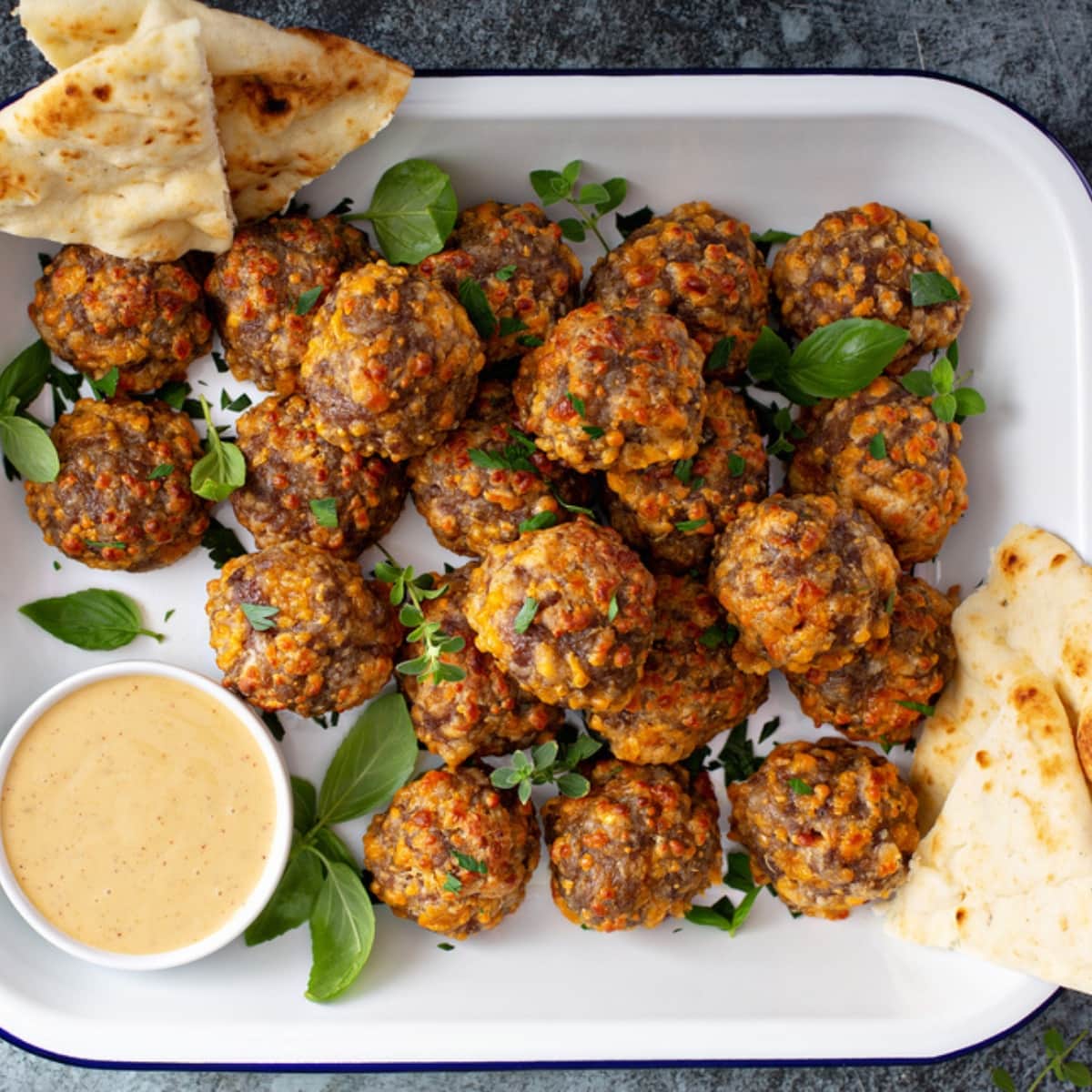 Jimmy Dean Sausage Balls on a Dish With Dips and Pita Bread