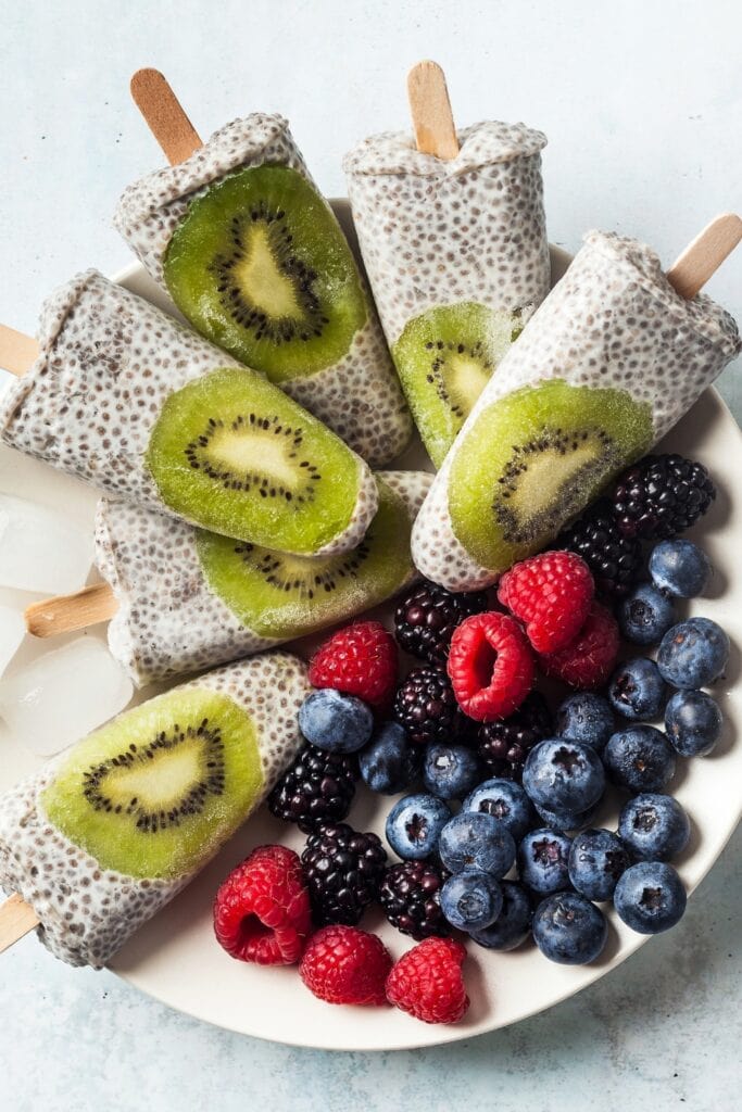 Kiwi and coconut lollipops with berries and chia seeds