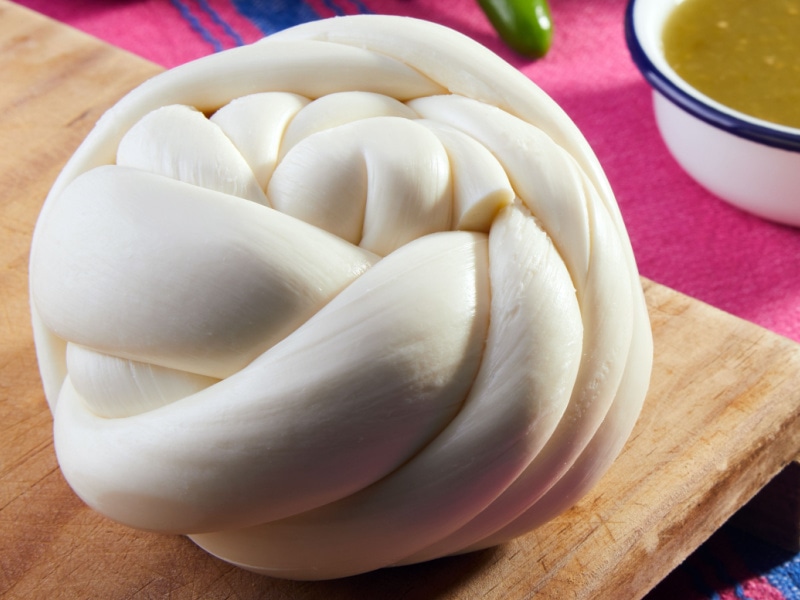 Traditional Mexican Oaxaca Cheese on a Wooden Cutting Board