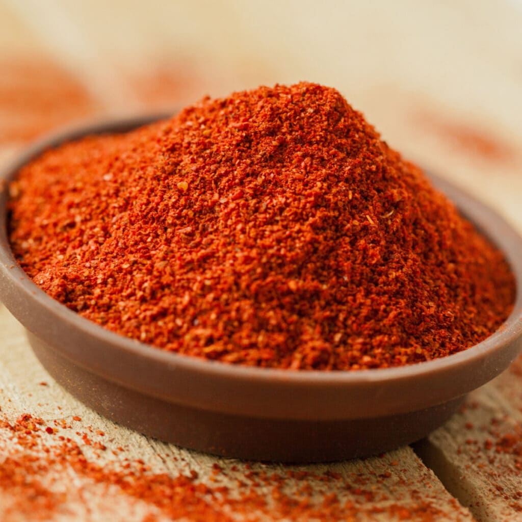 What is Paprika (All You Need to Know): Paprika Powder in a Dish Sitting On a Wooden Table 