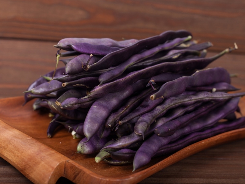 Purple String Beans on a Wooden Plate
