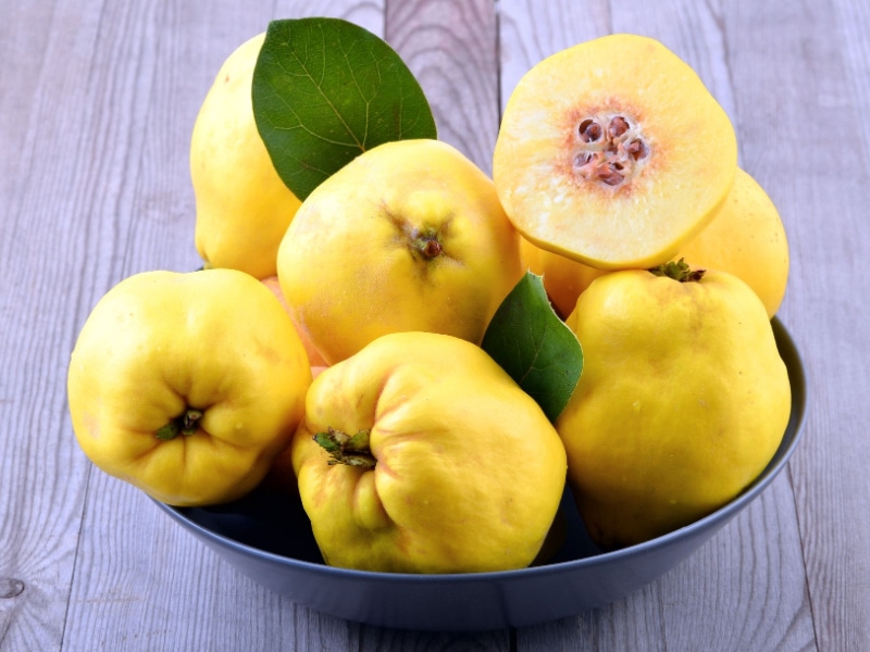 Whole and Slice Quince Fruit in a Bowl